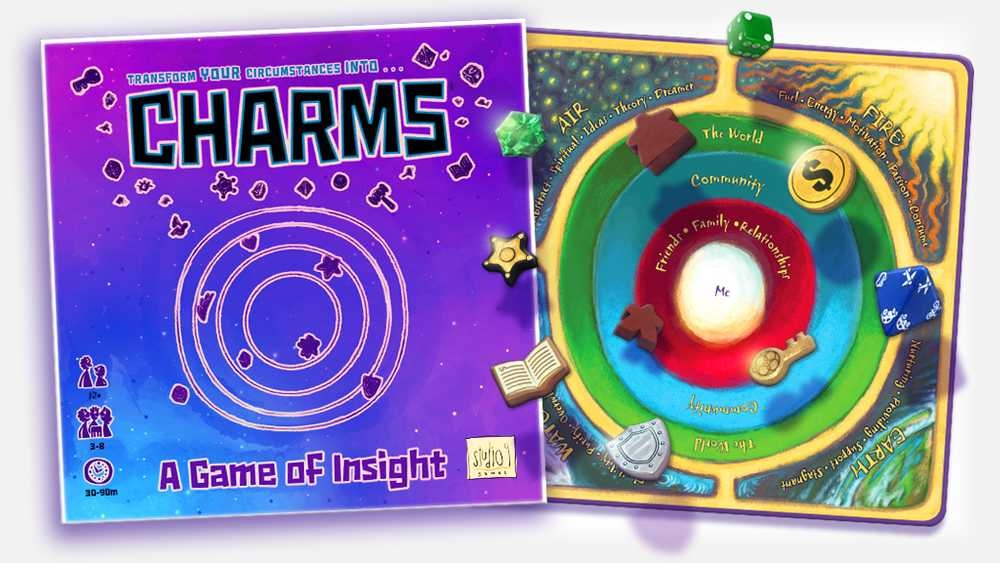 An opened box revealing the board and floating pieces used in CHARMS: A Game of Insight.